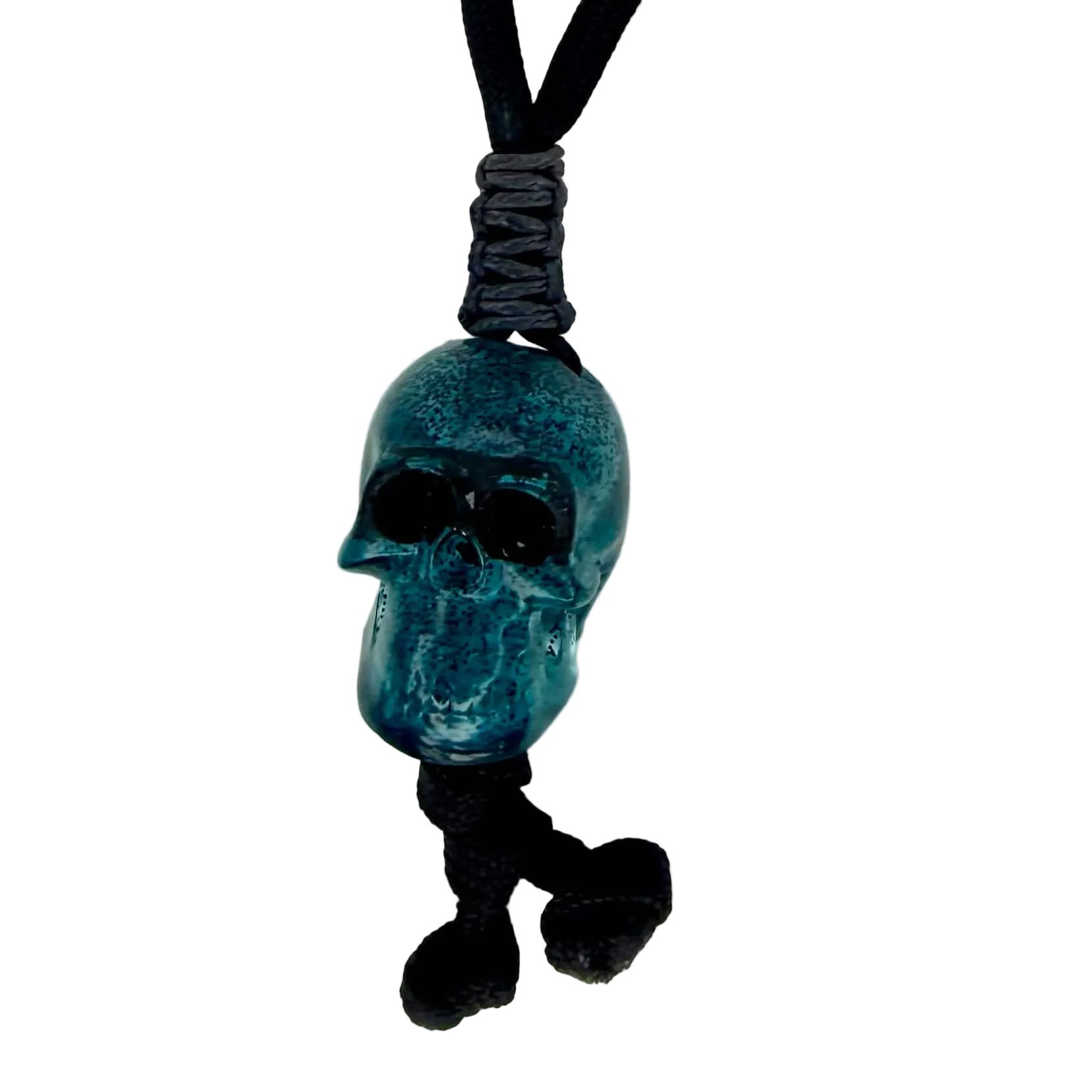 Blue skull charm on a black cord with 'REDACTED' label above on a white background